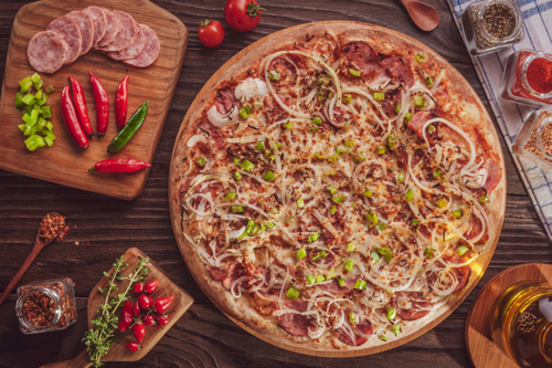 Cauliflower Pizza with sausage, peppers, and onions